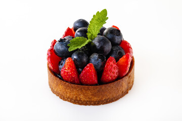 The cake with blueberries, strawberry and leaves of mint.