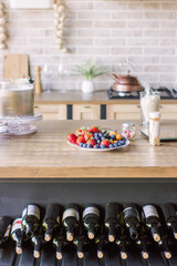 fresh strawberries, blueberries on a white plate, in the kitchen