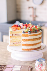 Cake, cut in half, decorated with fresh strawberries, blueberries