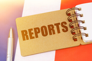 On the flag of France lies a notebook with the inscription - Reports