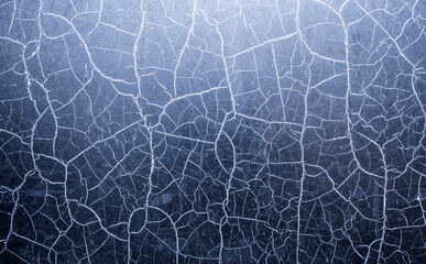 Many chaotic cracks on the surface of the textured material.