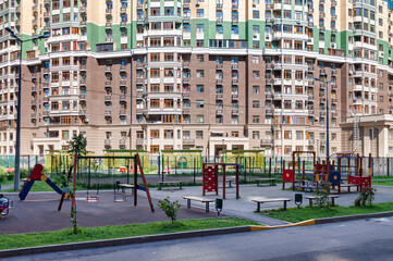 Fototapeta na wymiar Children playground house building facade mixed-use urban multi-family residential district area settings