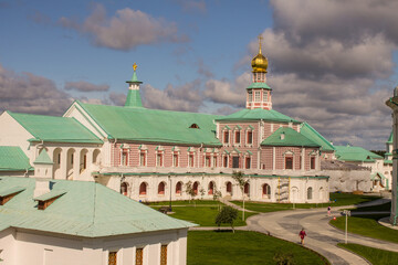 the Church of the Nativity of Christ with a golden dome in the New Jerusalem monastery on a sunny summer day and a blue sky with white clouds in Istra Moscow region