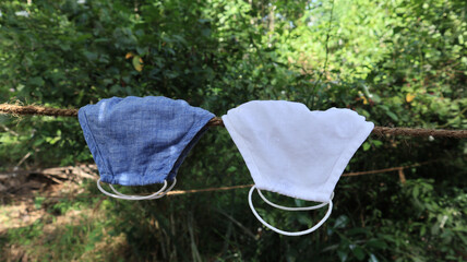 Close up of two cloth face mask hung on a rope