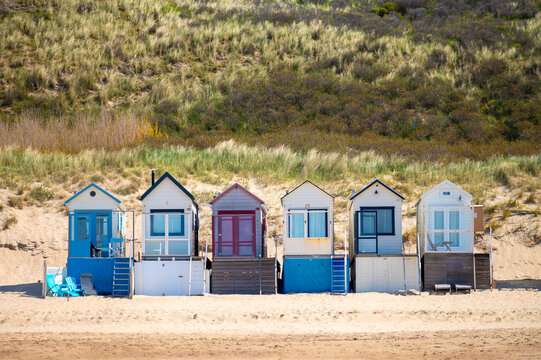 Small beach huts on white sandy North sea beach near Zoutelande, Zeeland, Netherlands