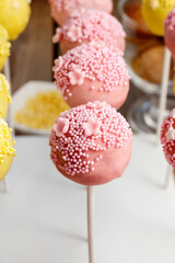 Yellow and pink cake pops.