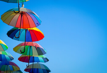 street decorated with colorful umbrellas in the blue sky
