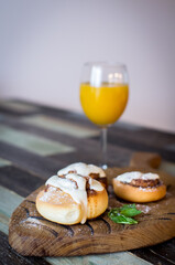 Homemade buns with cinnamon and a glass of juice