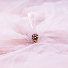 Jewelry in pink fabric. Wedding ring for a marriage proposal. 
