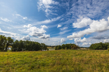 Fototapeta premium Beautiful landscape view on summer day on blue sky with white clouds background. Sweden.