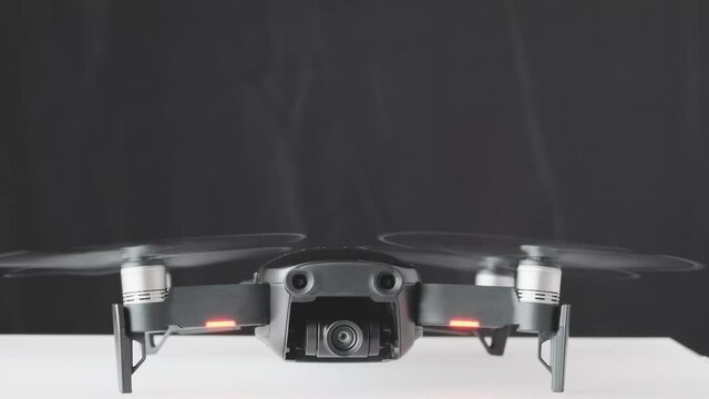 Drone quadcopter engine initiation front view, futuristic gadget and electronics, professional tool for video and photo 60 fps 4K