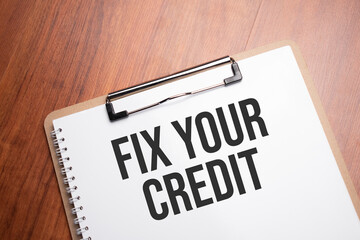 fix your credit text on white paper on the wood table