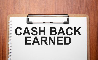 cash back earned text on white paper on the wood table