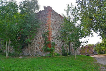 Fototapeta na wymiar A fragment of the building of the church of Kussen (XVIII century). Vesnovo village, Kaliningrad region