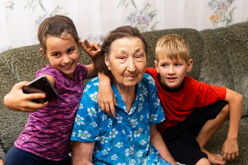 Grandmother with grandchild. Old woman with children