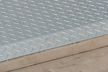 Fototapeta premium metal plate with anti-slip pattern and wood planks 