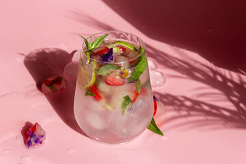 Non-alcoholic cocktail with frozen strawberries, mint and flowers.