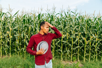 Young African American afro farmer man with hat thinking looking tired and bored with depression...