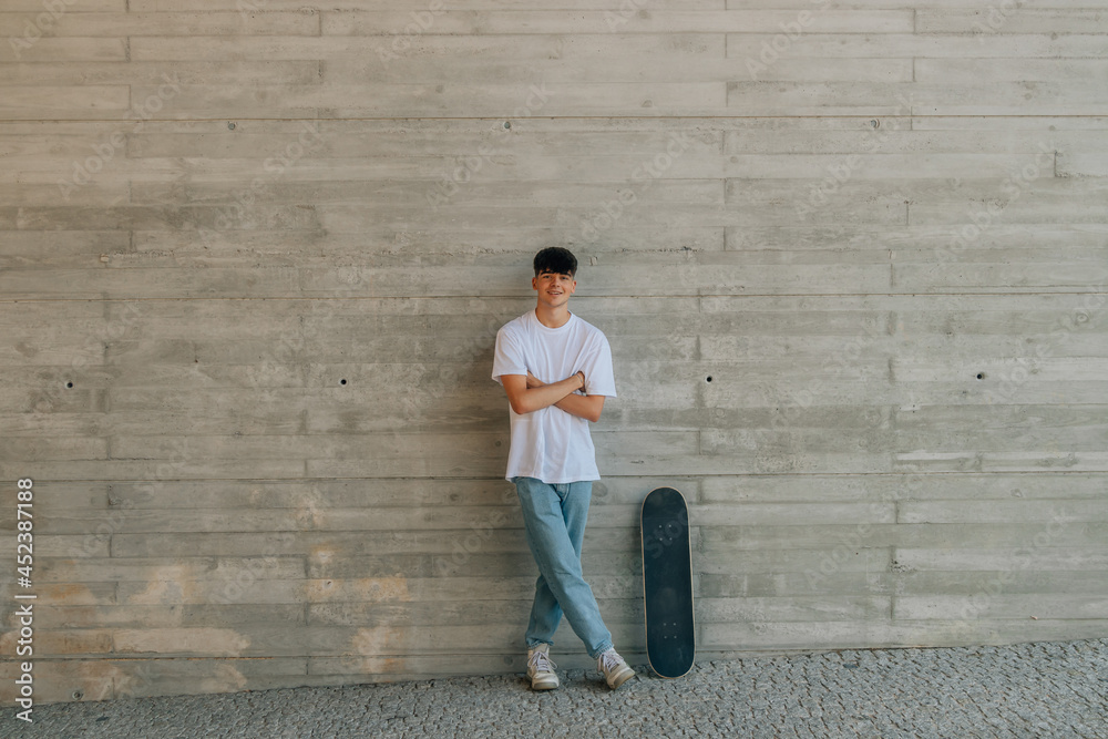 Sticker teen boy with skateboard on wall with copy space