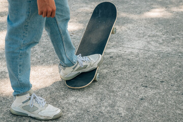 closeup of feet of young man with skateboard