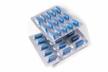 Packs of blue medical capsules on a white background