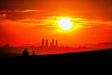 Naklejka premium Panoramic of the area of the four towers of Madrid at sunset with the sun in the background
