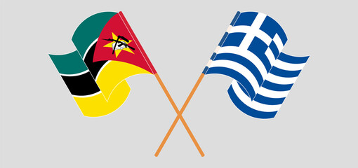Crossed and waving flags of Mozambique and Greece