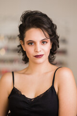 young hispanic woman in a beauty salon with makeup for skincare