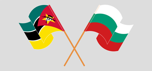 Crossed and waving flags of Mozambique and Bulgaria