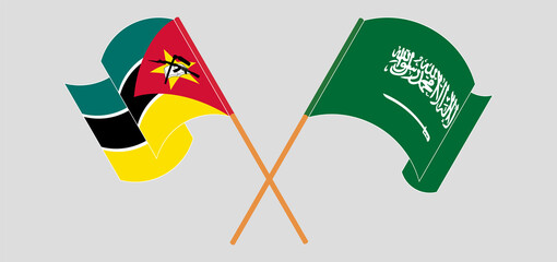 Crossed and waving flags of Mozambique and the Kingdom of Saudi Arabia