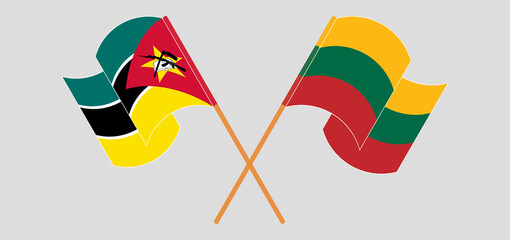 Crossed and waving flags of Mozambique and Lithuania