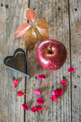 apple and heart on a wooden table