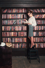 Confident business woman in the classical library room.