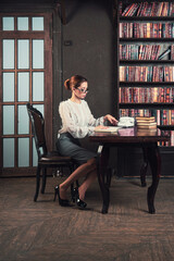 Confident business woman in the classical library room.