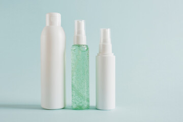 several different pump classic bottle for cosmetic products, cosmetic container on a light blue background