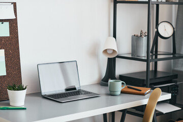 Clean background image of minimal home office workplace with laptop and accessories, copy space