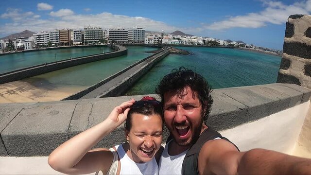 Spanish Holidays. happy tourist enjoying her summer vacations in Lanzarote, Canary Islands taking selfi photo with landscape. slow motion video