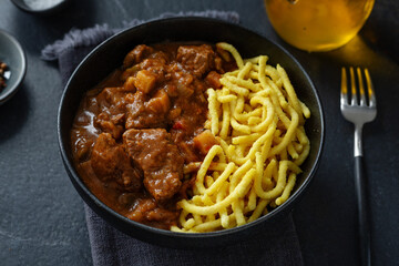 Meat ragout stew with noodles in bowl
