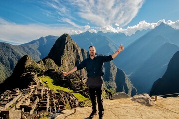 latin tourist on Machu Picchu with thumbs up, Peru
