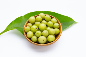 Fresh emblica in wooden bowl on white background.