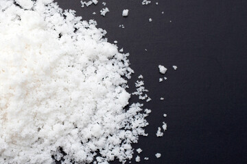 White salt on dark background.