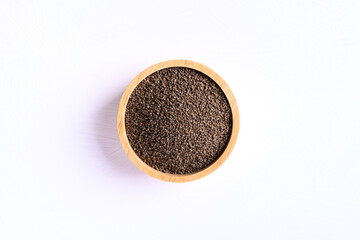 Perilla seeds in a wooden bowl on white background, Healthy herbal seed ingredients in Asian food, Top view