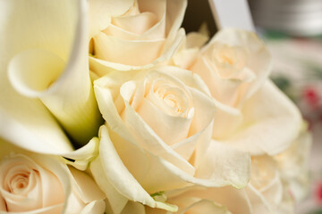 A view of several white roses and calla lilies box bouquet.
