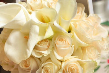 A view of several white roses and calla lilies box bouquet.