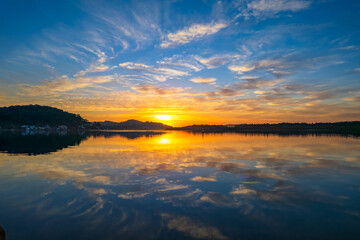 Sunrise waterscape with high cloud and reflections