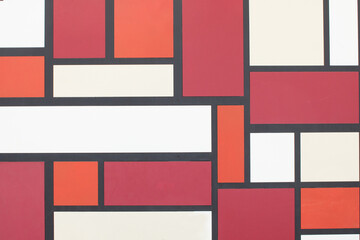 A view of a wall with different shaped square and rectangles in different colors, as a background.