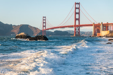 Landscape of Golden Gate bridge over sea horizon from Baker beach.