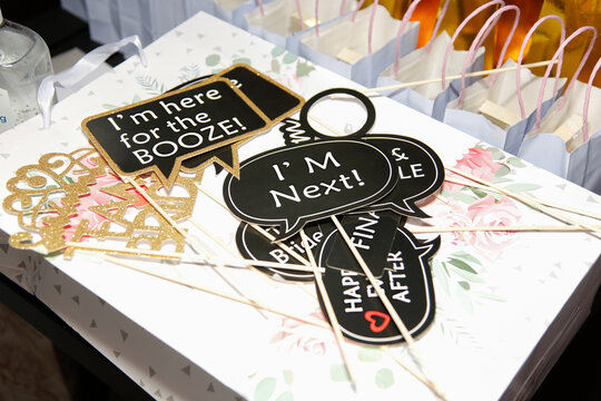A view of several wedding reception photo booth signs. 