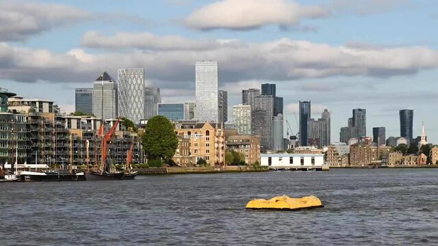 TImelapse City VIew of London's Canary Wharf Along the River Thames with Beautiful Skyline Background