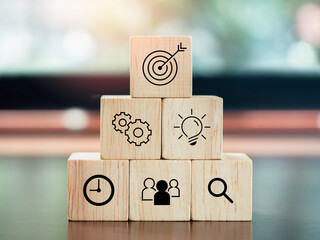 Modern business icons on wooden cube blocks, pyramid steps on desk. Leadership, key success,...